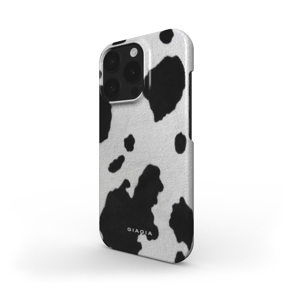 Phone case with black and white cow print design on a white background