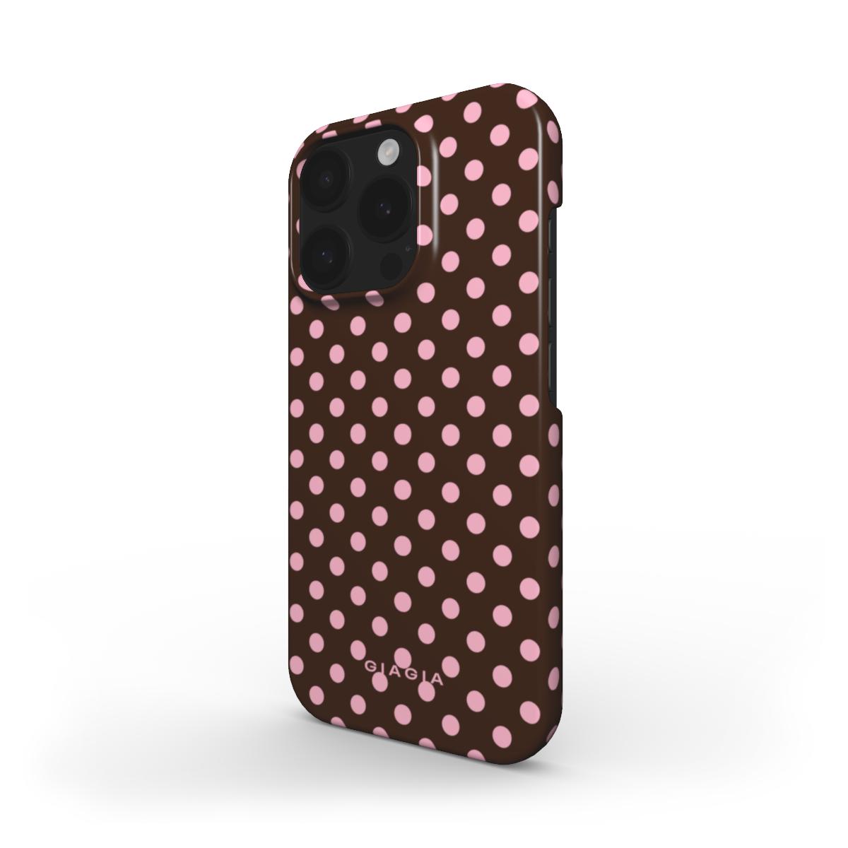 Phone case with pink polka dots on a brown background
