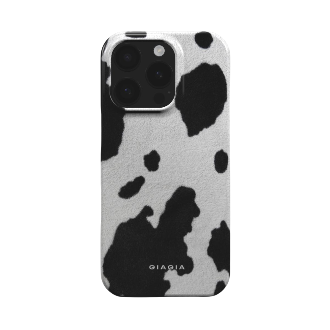Phone case with black and white cow print pattern on a white background